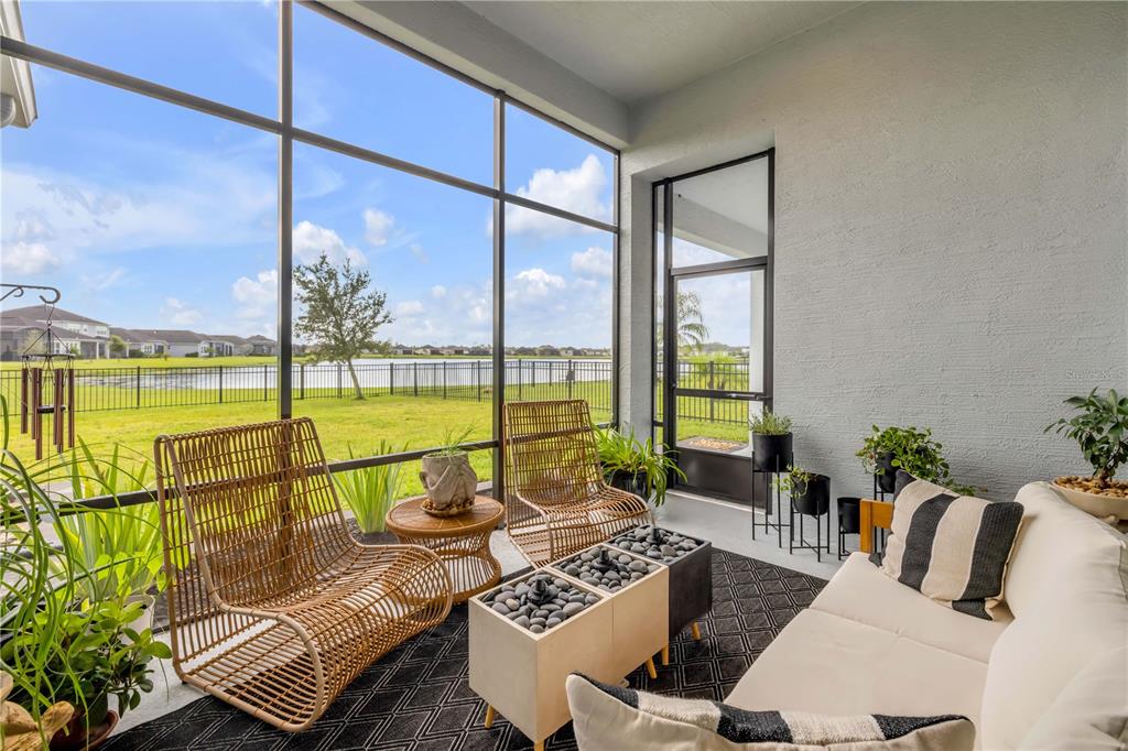 195 Azure Mist Way Daytona Beach, FL 32124 - Photo 46 of 63 a living room with furniture and floor to ceiling windows