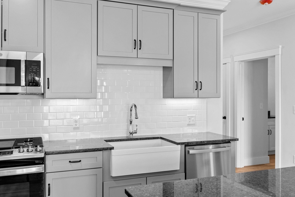 57 Long Point Road, Unit 309 Lakeville, MA 02347 - Photo 4 of 24 a kitchen with stainless steel appliances granite countertop a sink stove and cabinets