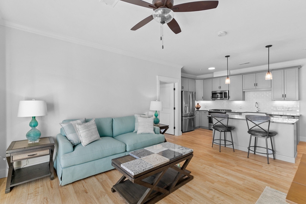 57 Long Point Road, Unit 309 Lakeville, MA 02347 - Photo 6 of 24 a living room with furniture and kitchen view