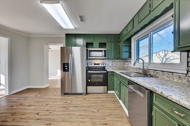 a view of a hallway with wooden floor and staircase