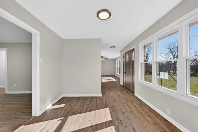 a view of a room with wooden floor