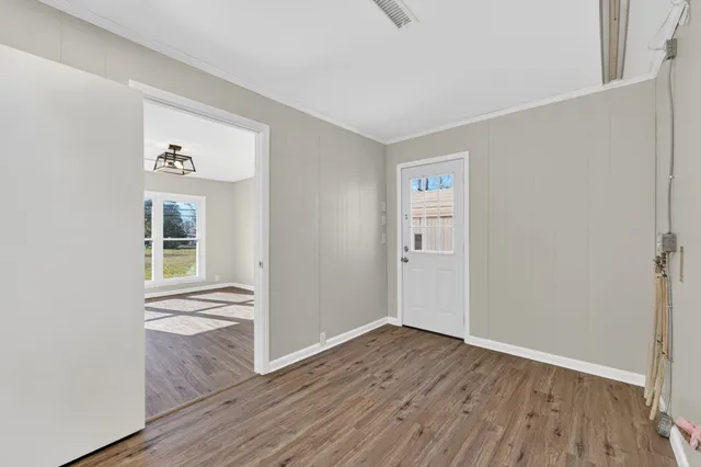 wooden floor in an empty room with a window