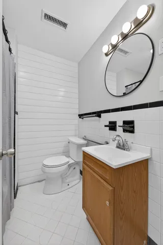 a view of a big room with wooden floor and windows