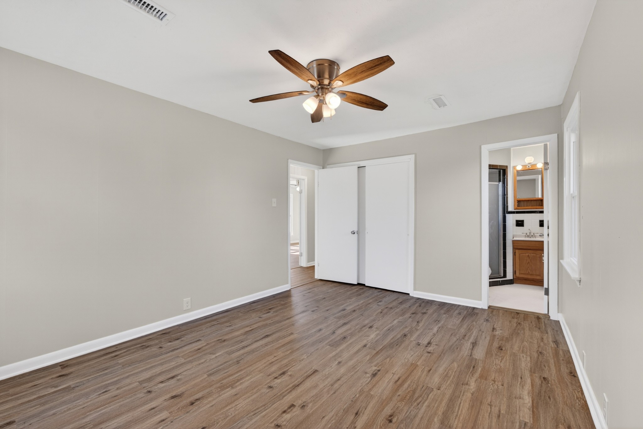 8 East Prospect Road Fayetteville, TN 37334 - Photo 23 of 42 a view of an empty room with wooden floor and a ceiling fan
