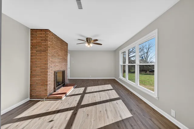 a view of wooden floor windows and chandelier in a room