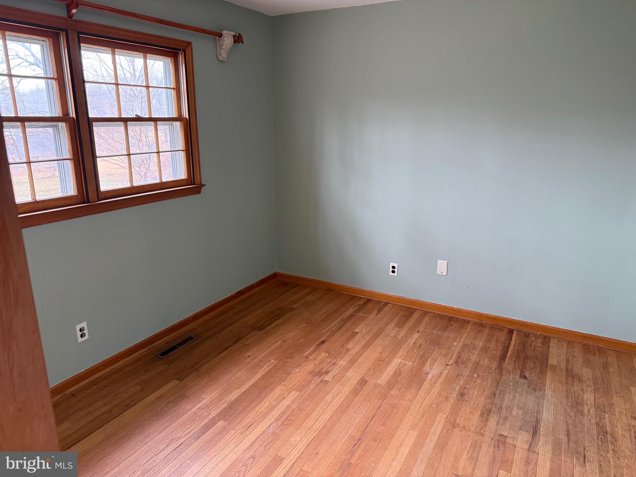 448 Lake Avenue Pitman, NJ 08071 - Photo 12 of 24 an empty room with wooden floor and windows