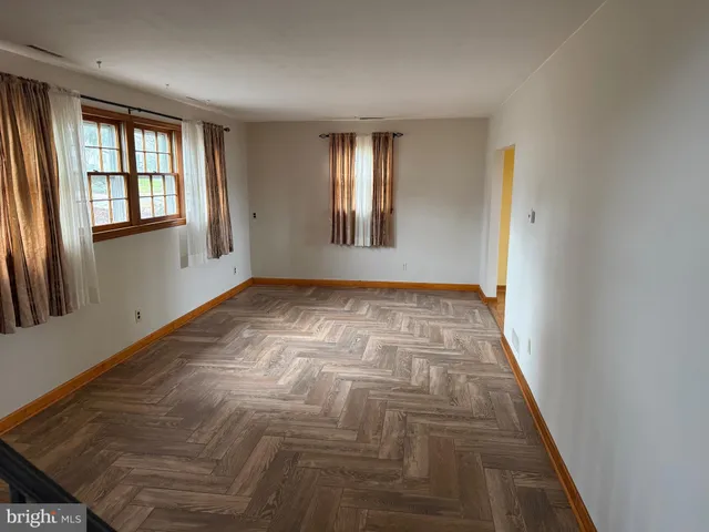 a view of an empty room with windows