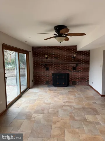a view of an empty room with a fireplace