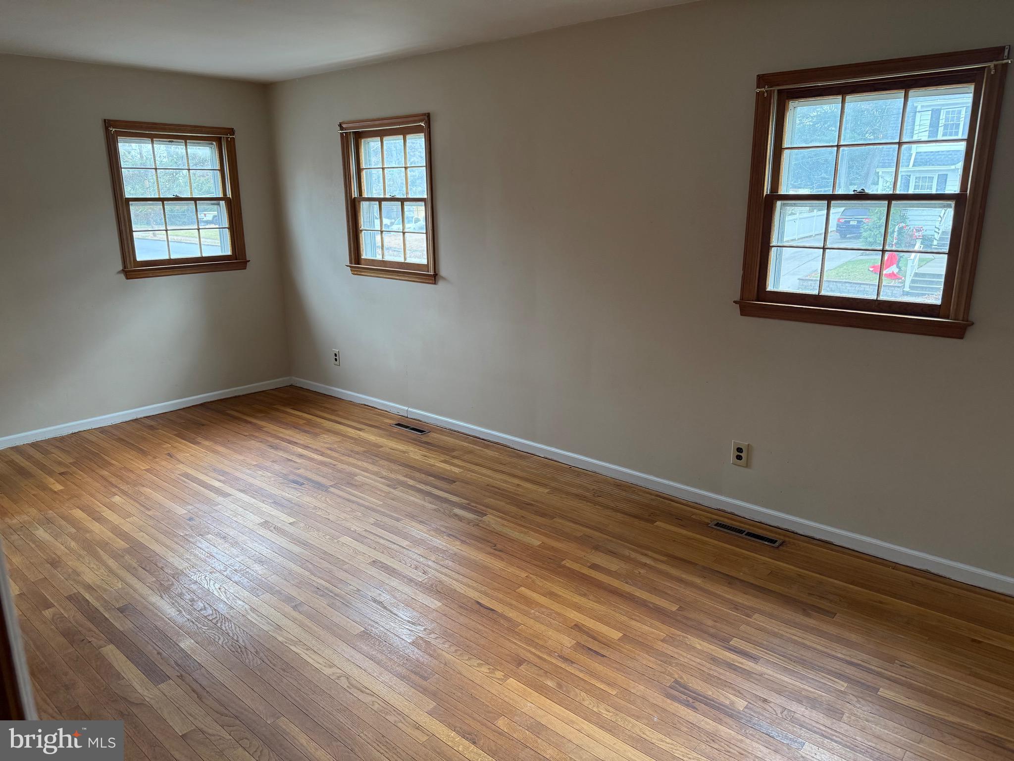 448 Lake Avenue Pitman, NJ 08071 - Photo 9 of 24 an empty room with wooden floor and windows