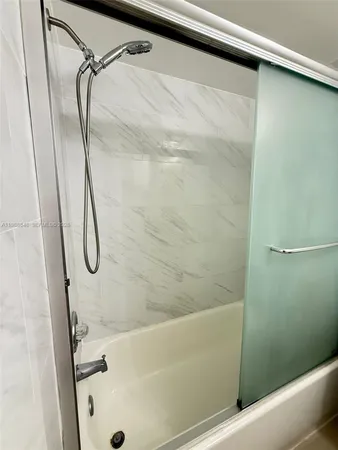 a bathroom with a shower and a shower