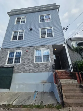 a front view of a house with stairs