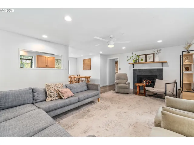 a living room with furniture kitchen view and a refrigerator