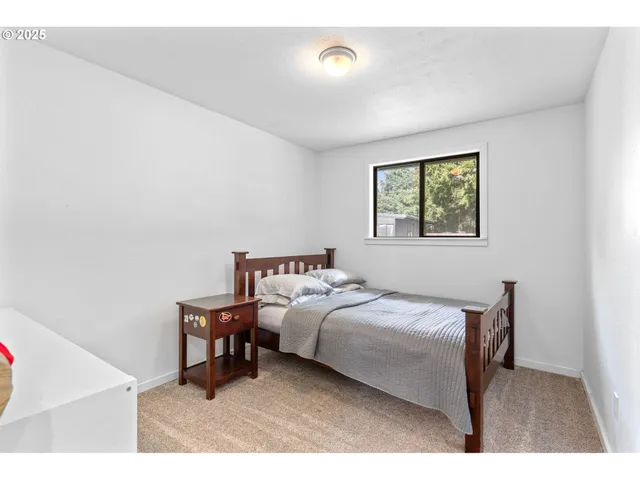 a bathroom with a granite countertop sink toilet and mirror