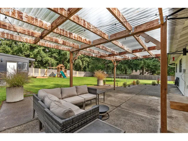 a backyard of a house with table and chairs