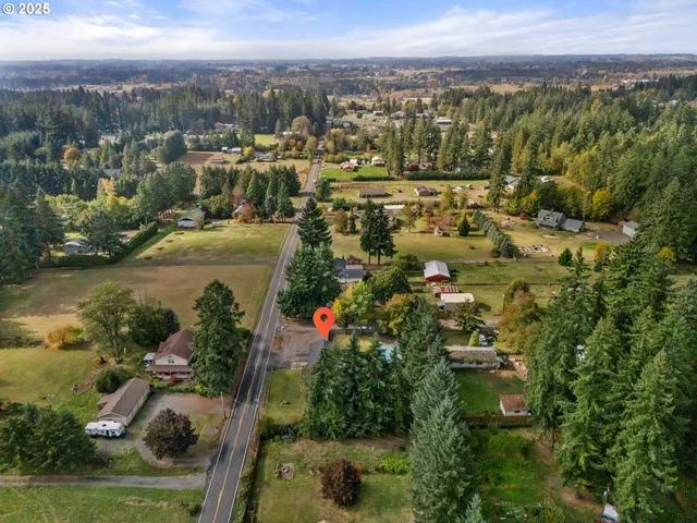 a view of a houses with a lush green forest