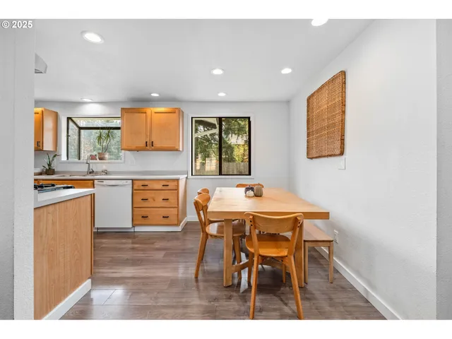 a kitchen with stainless steel appliances a stove a sink and a microwave