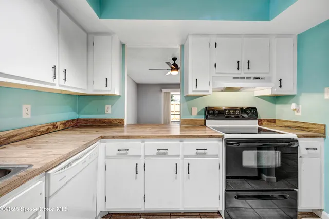a kitchen with white cabinets sink and white appliances