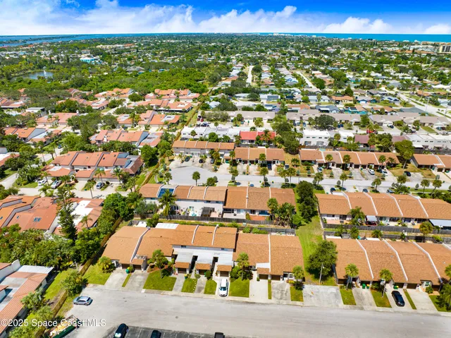 an aerial view of residential houses with outdoor space