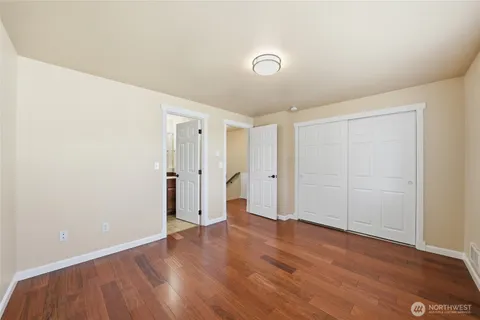 a bedroom with a bed and a night stand