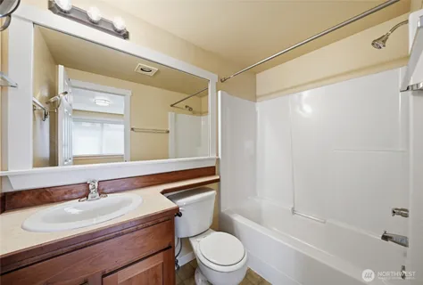 a backyard of a house with wooden fence and large windows