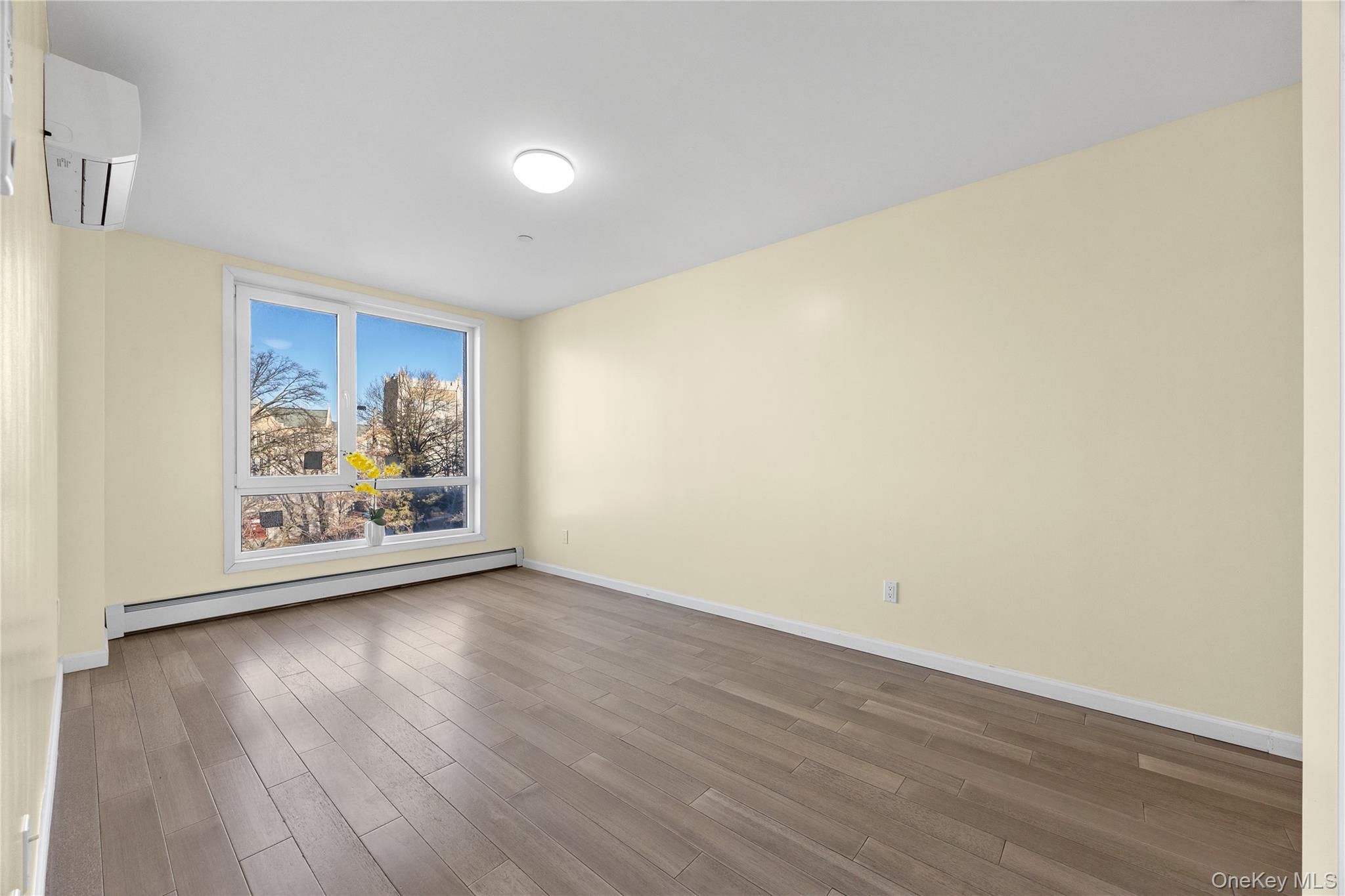 138-12 Northern Boulevard, Unit 5D Queens, NY 11354 - Photo 13 of 22 a view of an empty room with wooden floor and a window
