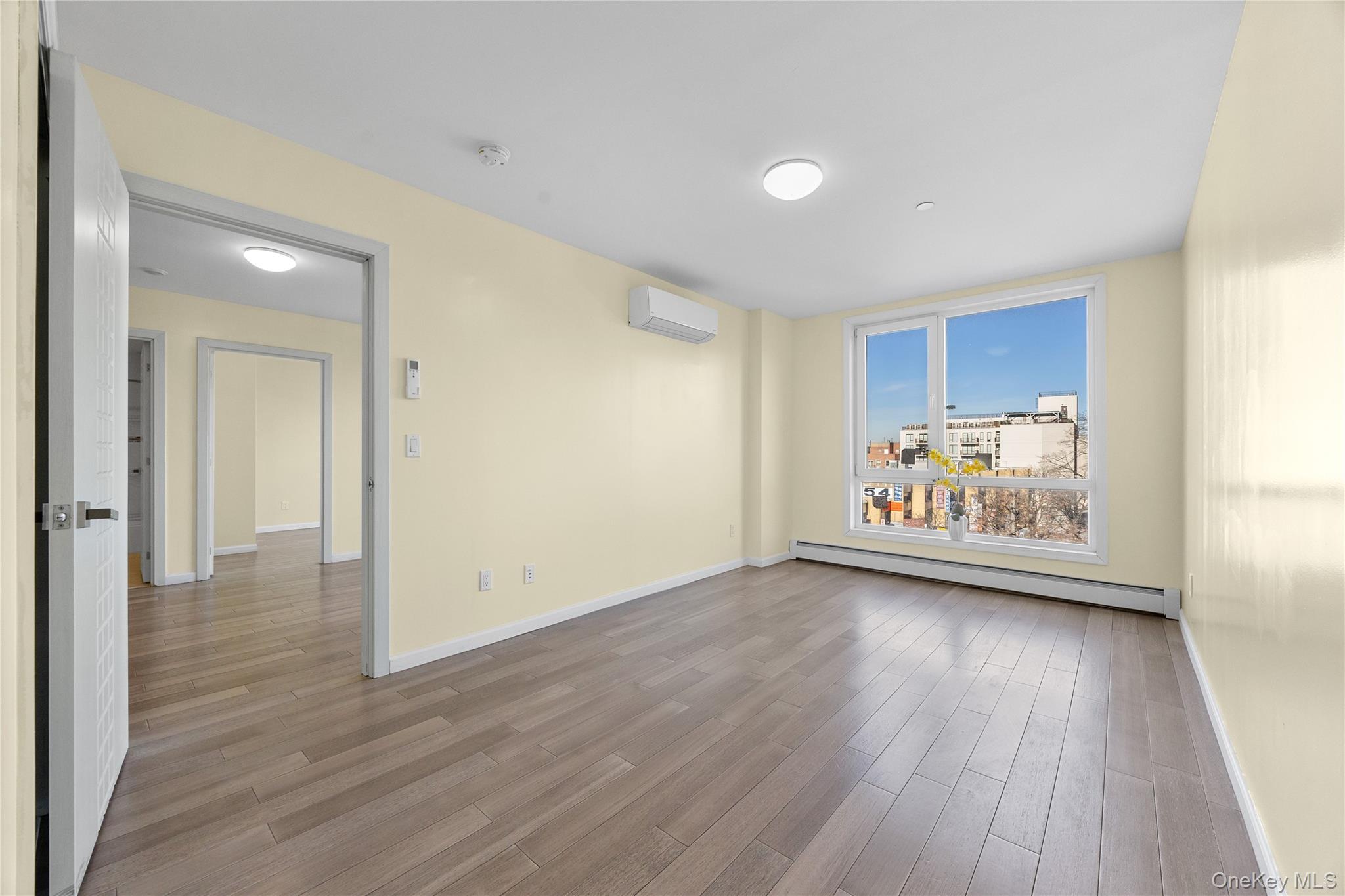 138-12 Northern Boulevard, Unit 5D Queens, NY 11354 - Photo 14 of 22 a view of an empty room and wooden floor