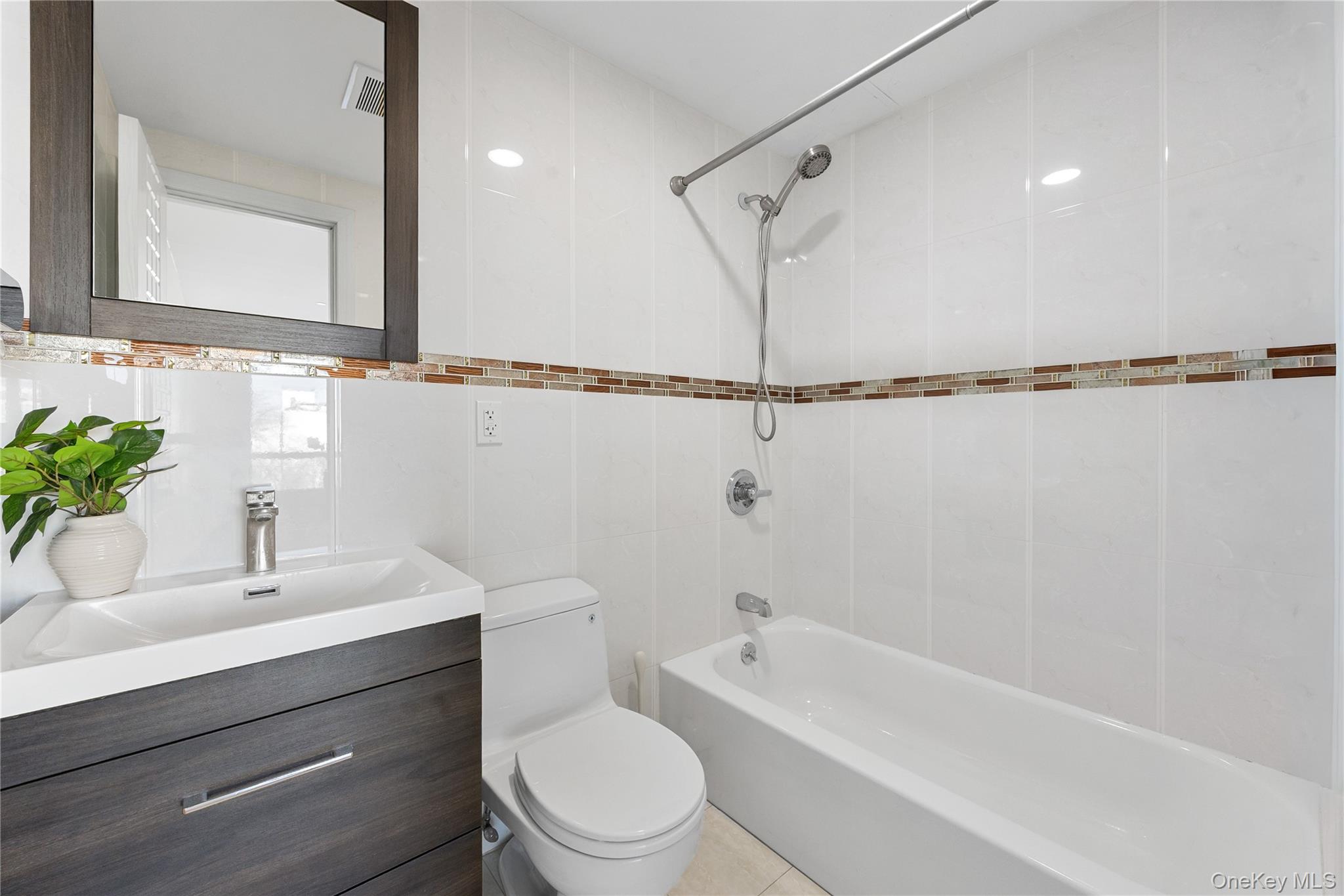 138-12 Northern Boulevard, Unit 5D Queens, NY 11354 - Photo 17 of 22 a bathroom with a sink a toilet and shower