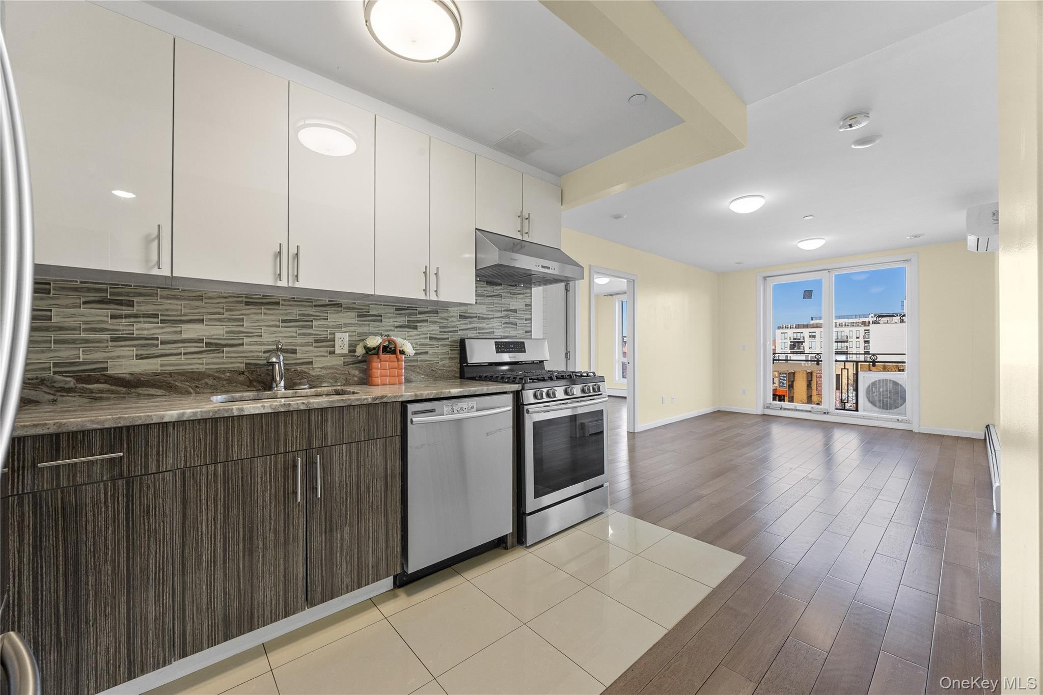 138-12 Northern Boulevard, Unit 5D Queens, NY 11354 - Photo 2 of 22 a kitchen with stainless steel appliances granite countertop a stove a sink and a refrigerator