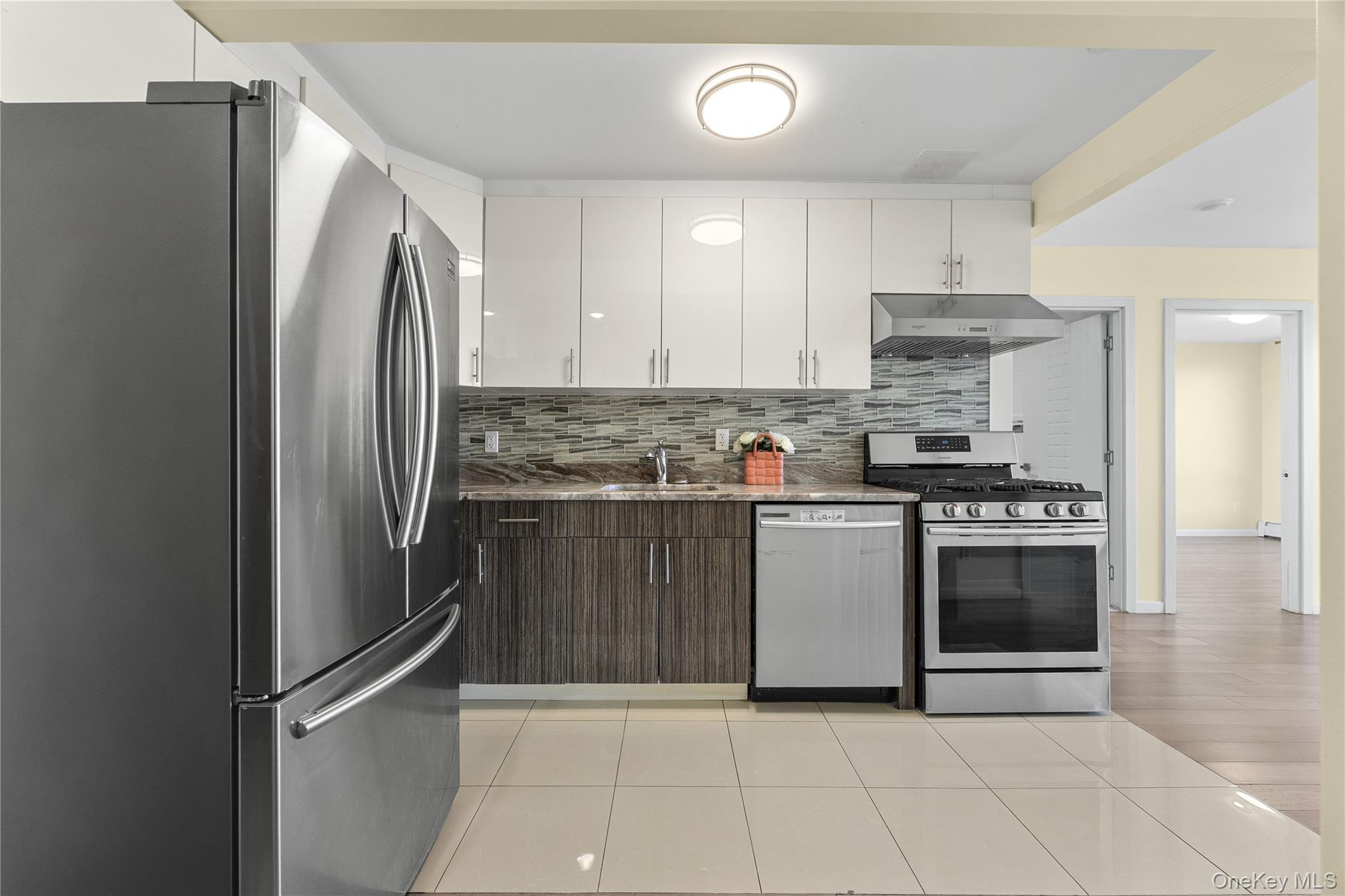 138-12 Northern Boulevard, Unit 5D Queens, NY 11354 - Photo 3 of 22 a kitchen with stainless steel appliances granite countertop a refrigerator and a stove