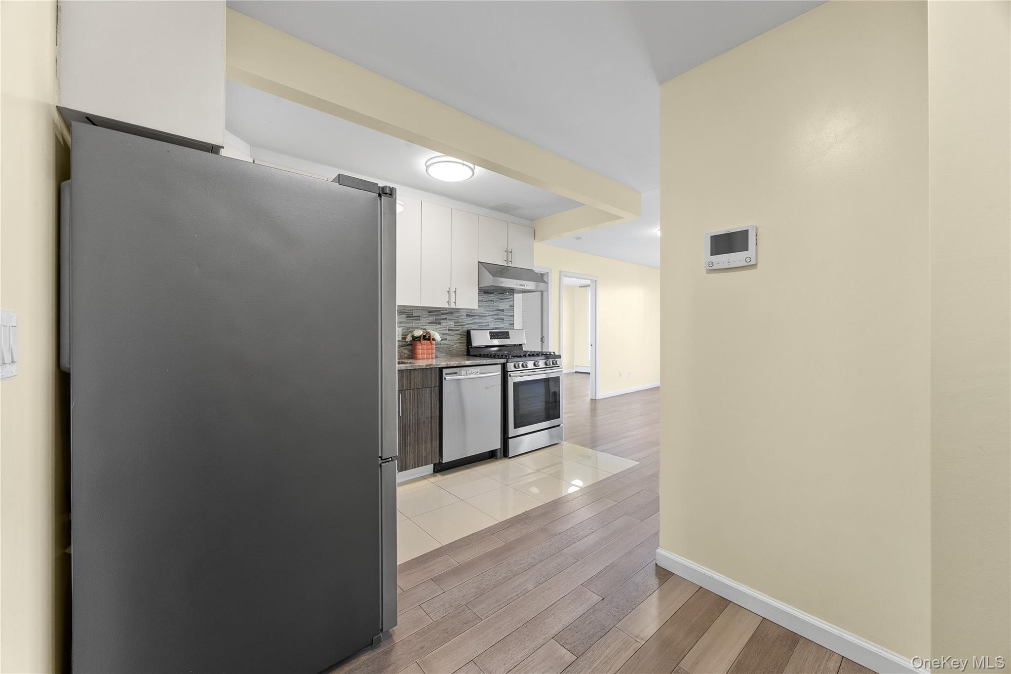 138-12 Northern Boulevard, Unit 5D Queens, NY 11354 - Photo 6 of 22 a kitchen with a refrigerator and a stove top oven
