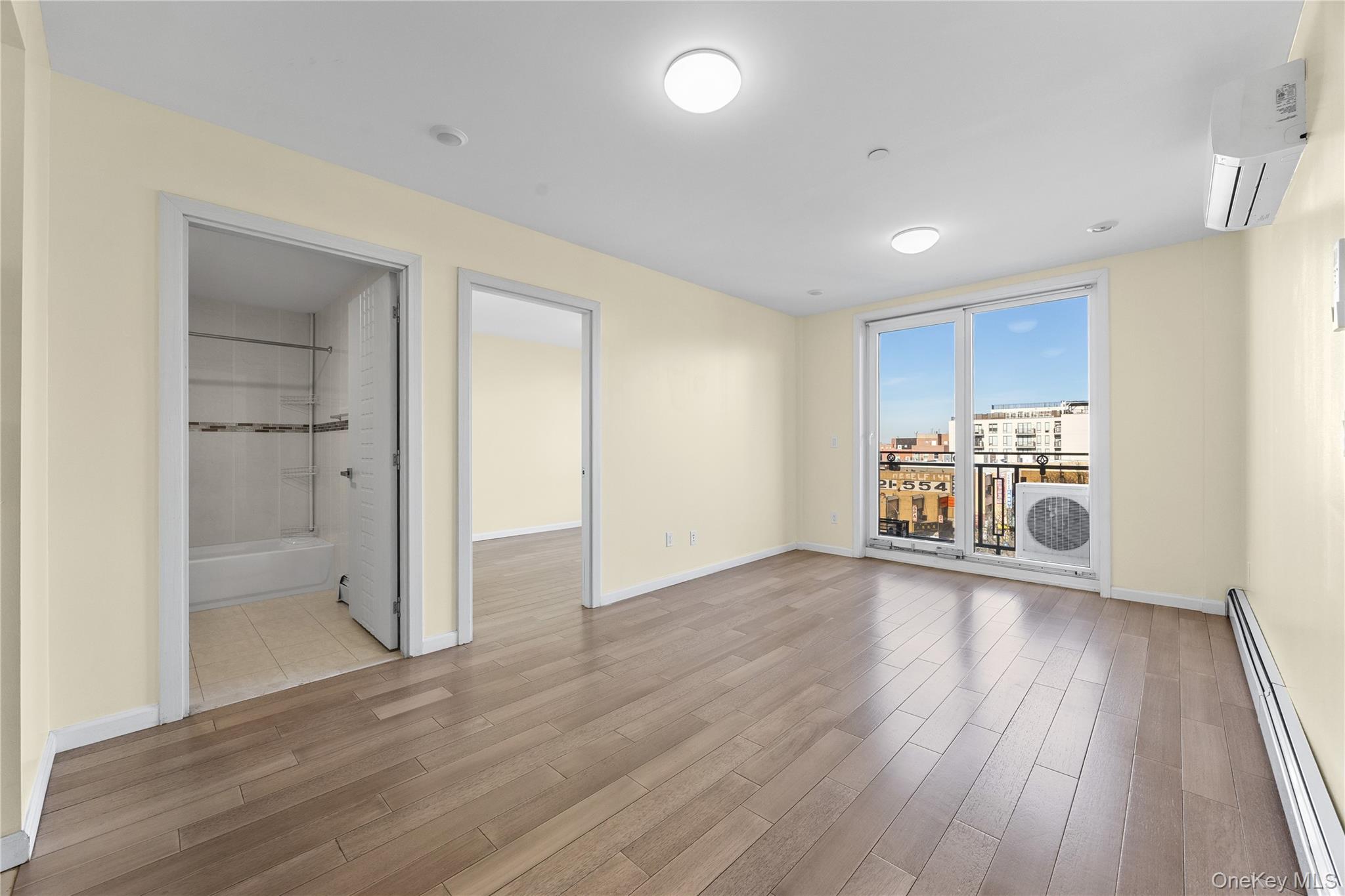 138-12 Northern Boulevard, Unit 5D Queens, NY 11354 - Photo 9 of 22 a view of a big room with wooden floor and windows
