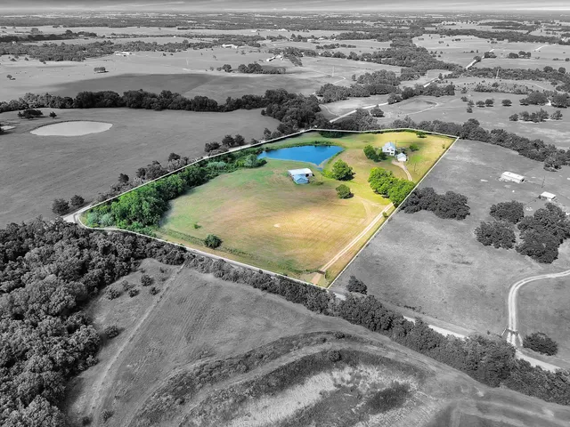 an aerial view of a house with a swimming pool