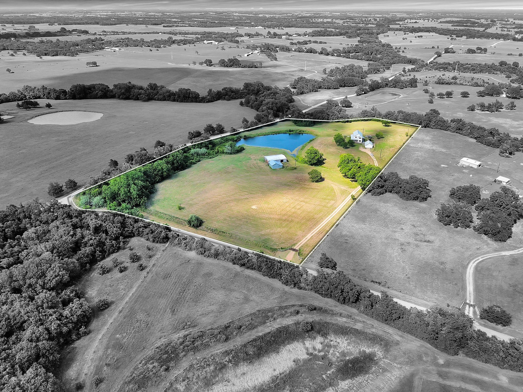 an aerial view of a house with a swimming pool