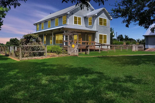 a view of a house with a yard and trees