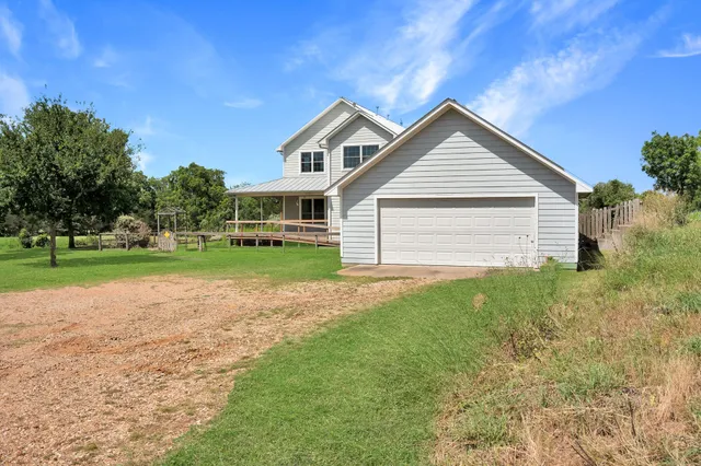 a view of a house with a yard and sitting area
