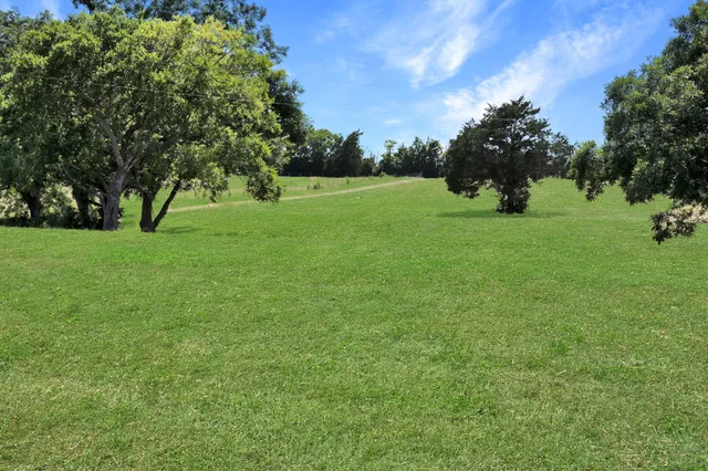 a view of a house with a garden and pathway