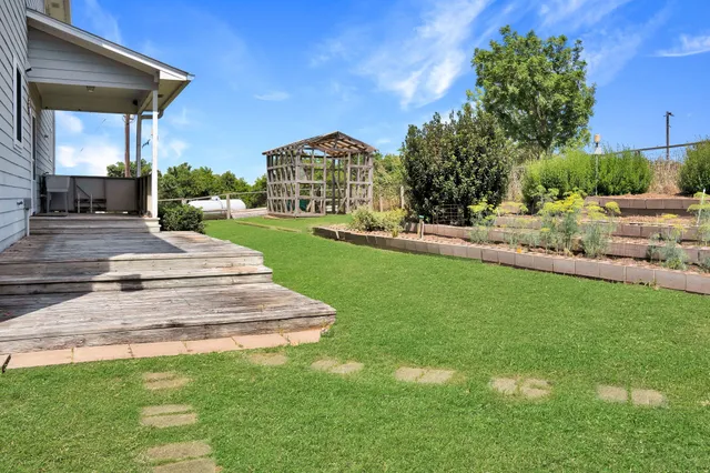 a view of a backyard with sitting area