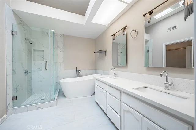 a spacious bathroom with a shower sink mirror and