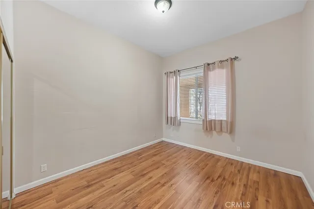 a view of wooden floor and windows in a room