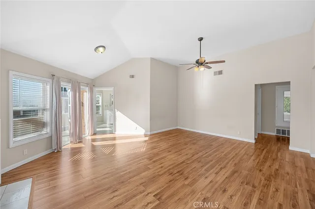 wooden floor in an empty room with a window