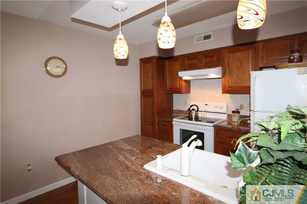 438 A Belford Road Monroe Township, NJ 08831 - Photo 11 of 19 a kitchen with a table and a stove