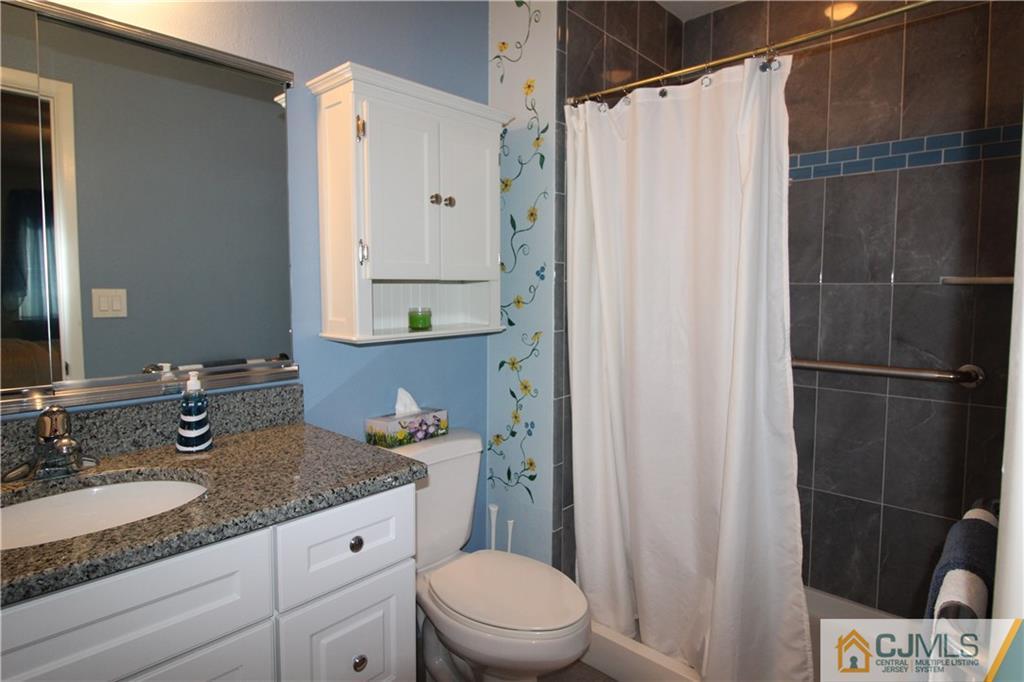 438 A Belford Road Monroe Township, NJ 08831 - Photo 14 of 19 a bathroom with a granite countertop sink toilet and shower