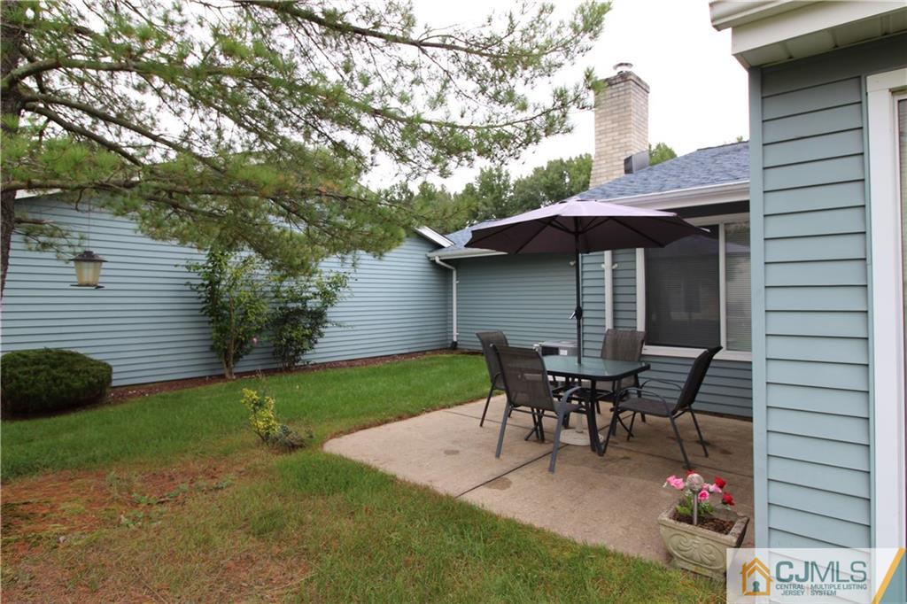 438 A Belford Road Monroe Township, NJ 08831 - Photo 19 of 19 a view of a patio with table and chairs and potted plants