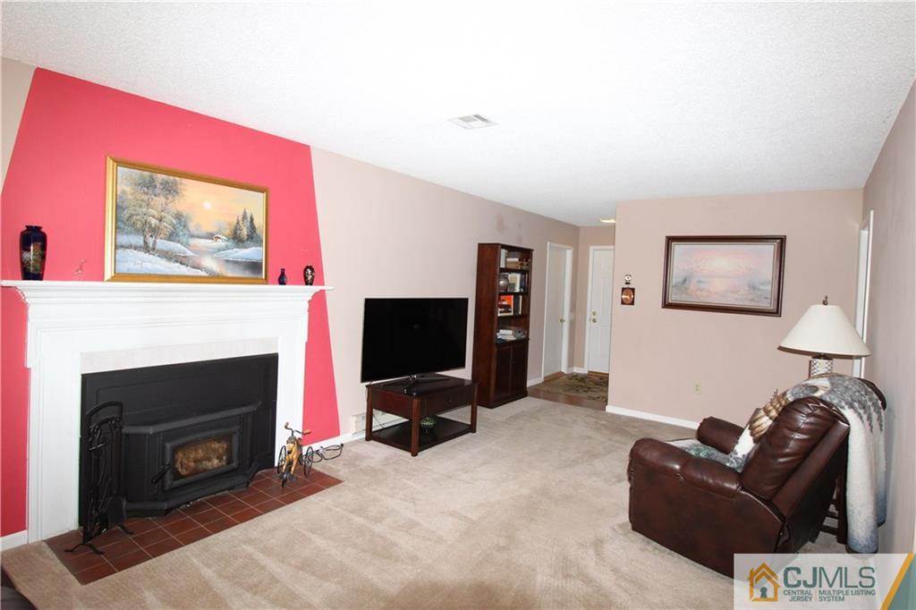438 A Belford Road Monroe Township, NJ 08831 - Photo 4 of 19 a living room with furniture a flat screen tv and a fireplace