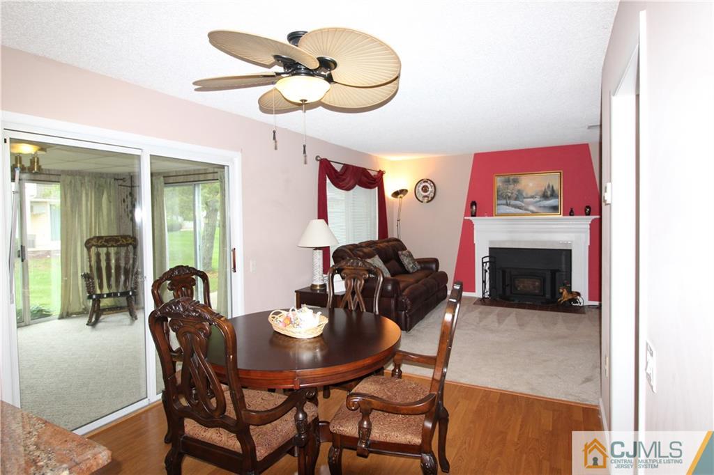438 A Belford Road Monroe Township, NJ 08831 - Photo 8 of 19 a dining room with furniture and a fireplace