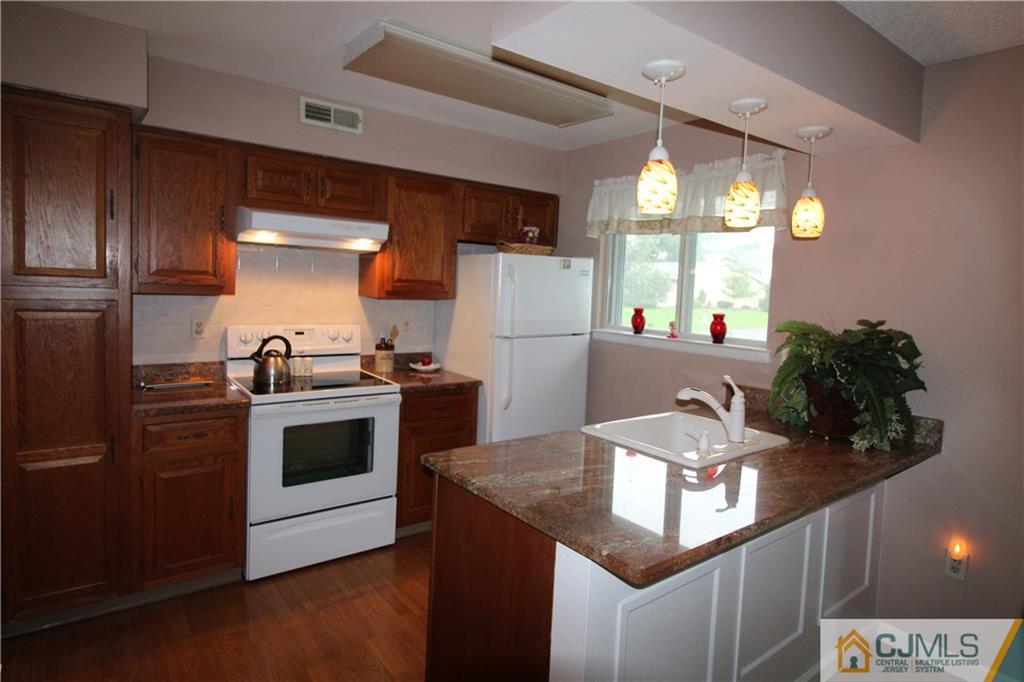 438 A Belford Road Monroe Township, NJ 08831 - Photo 9 of 19 a kitchen with granite countertop a sink a stove and refrigerator