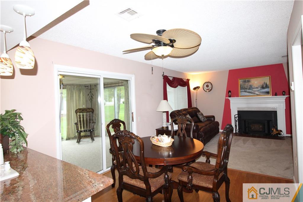 438 A Belford Road Monroe Township, NJ 08831 - Photo 10 of 19 a dining room with furniture and a fireplace