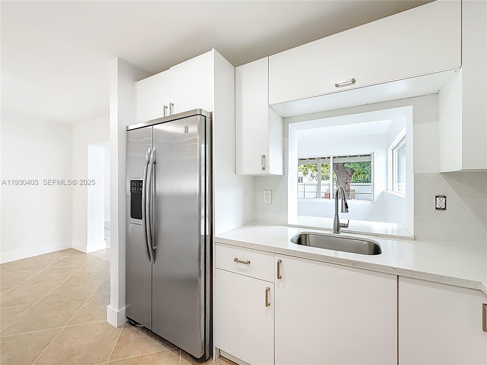 4008 Adams Street Hollywood, FL 33021 - Photo 14 of 54 a kitchen with refrigerator and window