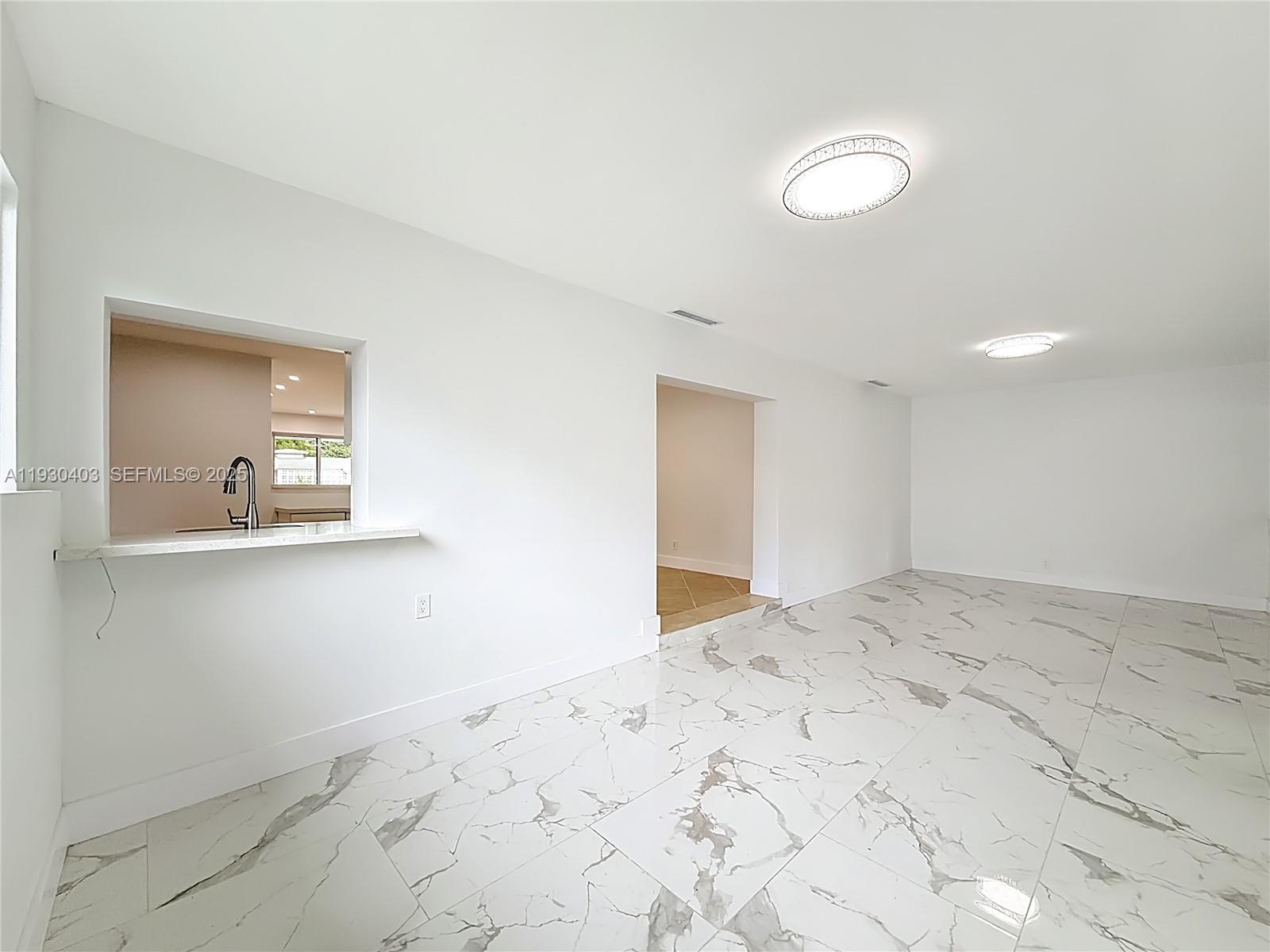 4008 Adams Street Hollywood, FL 33021 - Photo 31 of 54 a view of a livingroom with wooden floor and a bathroom sink