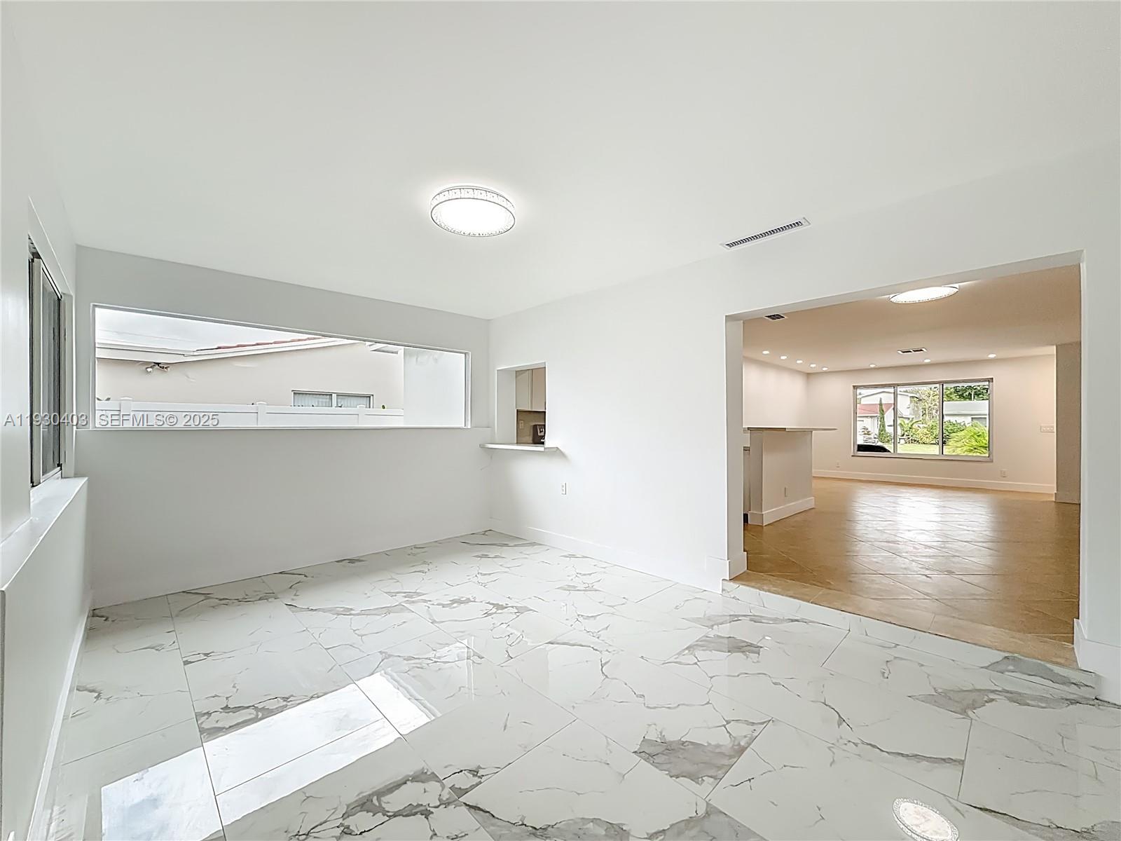 4008 Adams Street Hollywood, FL 33021 - Photo 34 of 54 a view of a hallway with wooden floor and a living room
